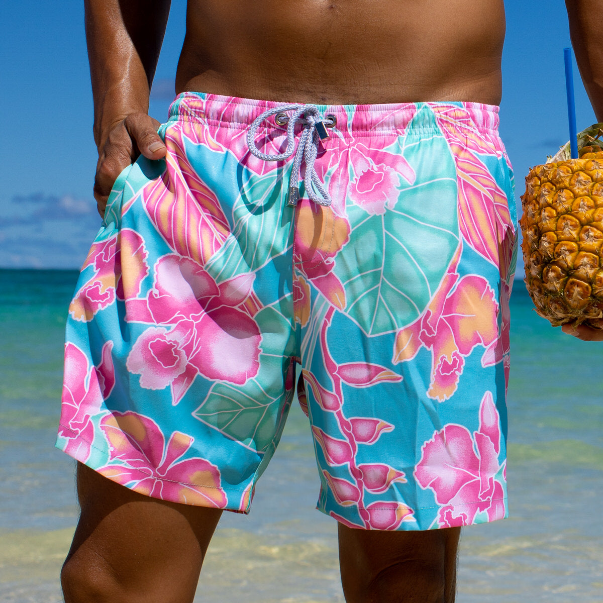 http://www.kennyflowers.com/cdn/shop/products/Maui-Print-Kenny-Flowers-Tropical-Vacation-Swim-Trunks-2022-beach-close-1.jpg?v=1642447011
